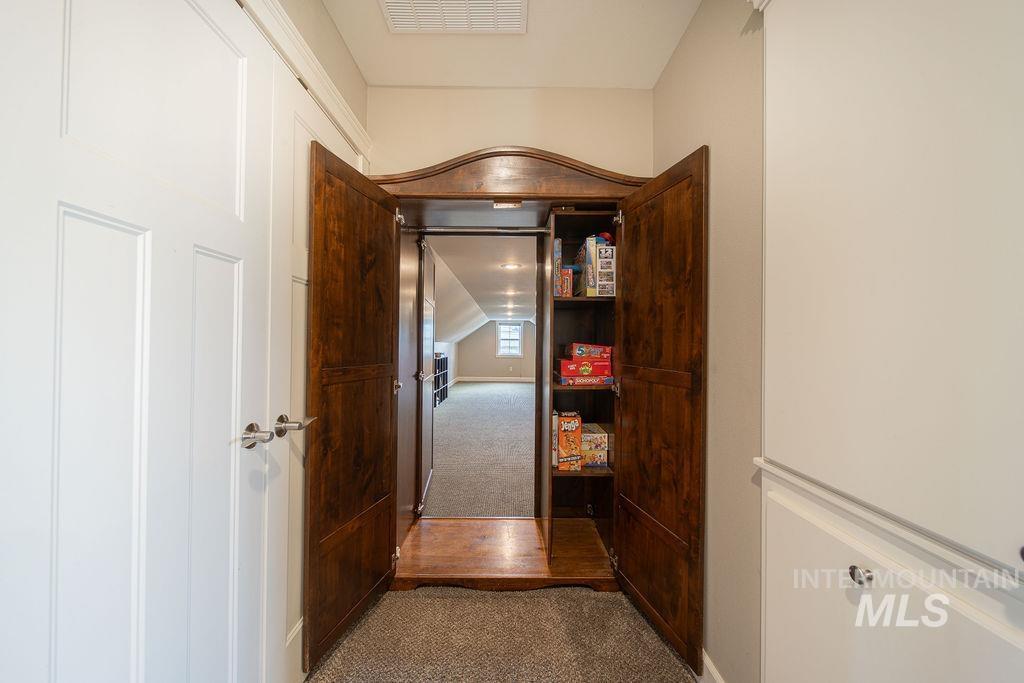 19809 Tammany Creek Road Lewiston, ID 83501 - Photo 36 of 50 Hall featuring dark carpet, dark wood-style flooring, and vaulted ceiling