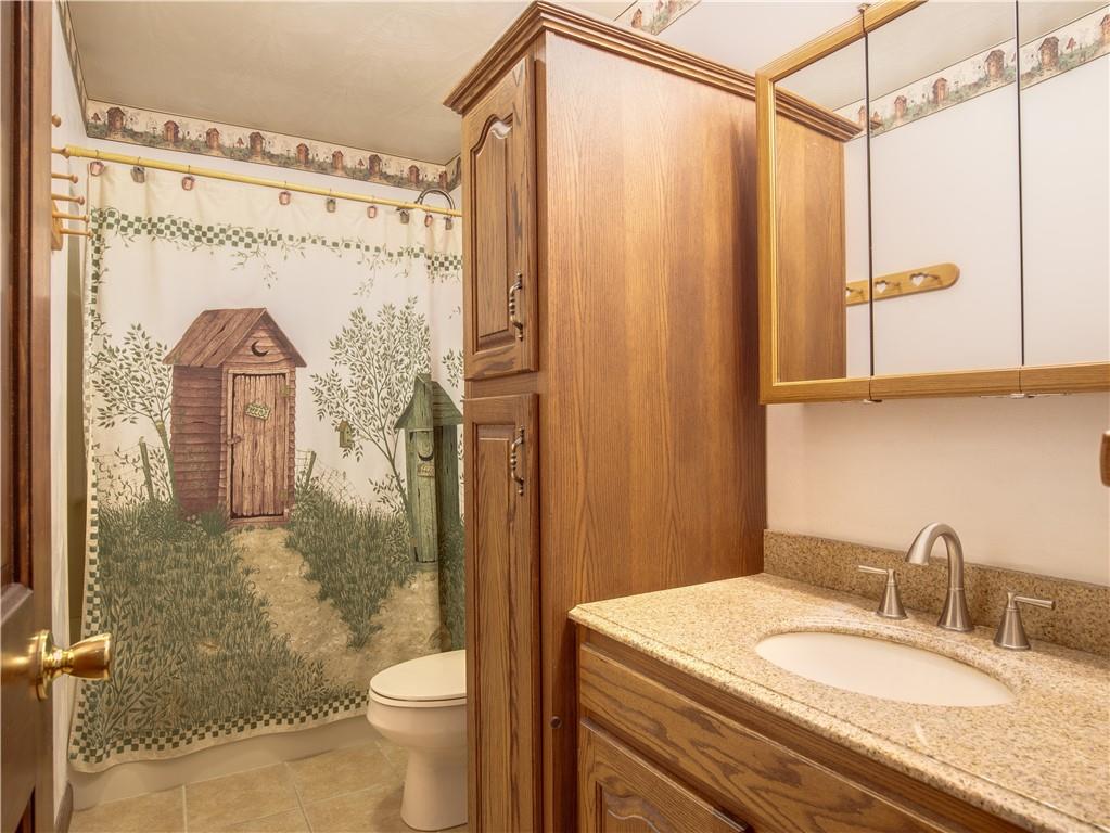 247 Medical Center Road Chicora, PA 16025 - Photo 14 of 24 a bathroom with a granite countertop sink toilet and shower