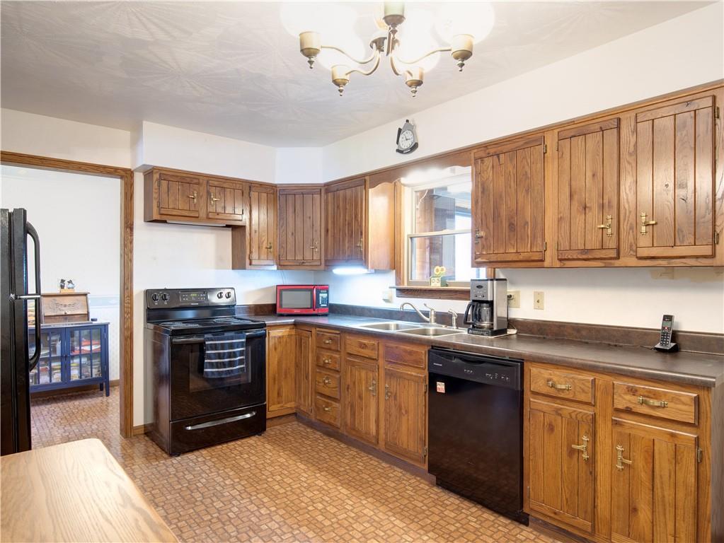 247 Medical Center Road Chicora, PA 16025 - Photo 8 of 24 a kitchen with stainless steel appliances granite countertop a sink a stove cabinets counter space and a window