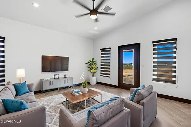 a living room with furniture and a flat screen tv