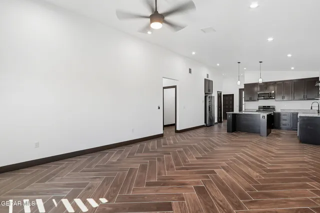 a view of kitchen with stainless steel appliances refrigerator stove microwave and cabinets