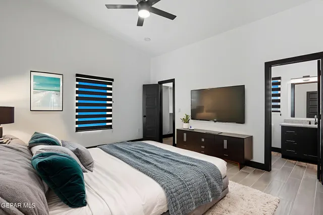 a bedroom with a bed and a flat screen tv