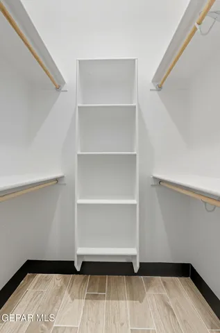 a view of walk in closet with empty racks