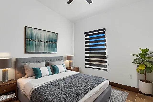 a bedroom with a bed and a window