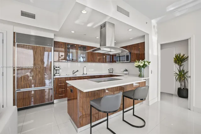 a kitchen with stainless steel appliances a sink and a refrigerator