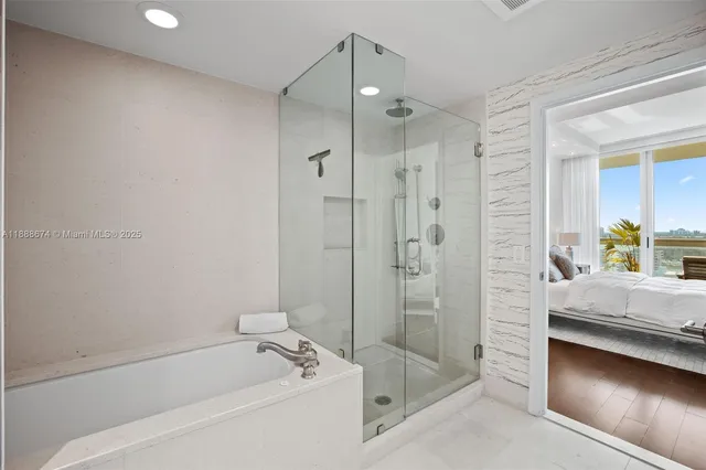 a bathroom with a tub shower vanity and a sink