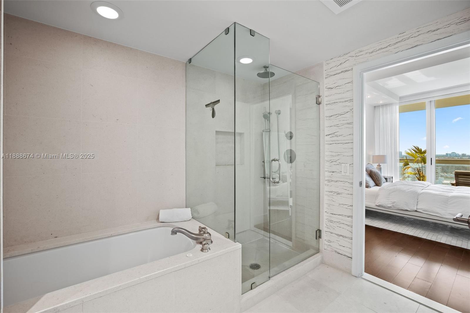 6899 Collins Avenue, Unit 1610 Miami Beach, FL 33141 - Photo 16 of 35 a bathroom with a tub shower vanity and a sink