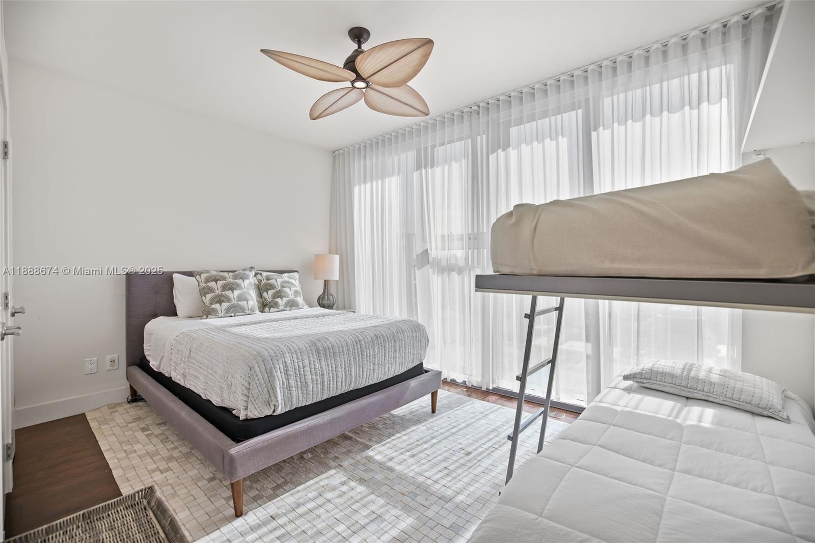 6899 Collins Avenue, Unit 1610 Miami Beach, FL 33141 - Photo 17 of 35 a bedroom with a bed and a large window