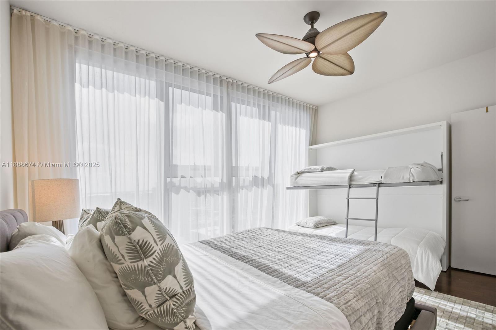 6899 Collins Avenue, Unit 1610 Miami Beach, FL 33141 - Photo 18 of 35 a bedroom with a bed and window