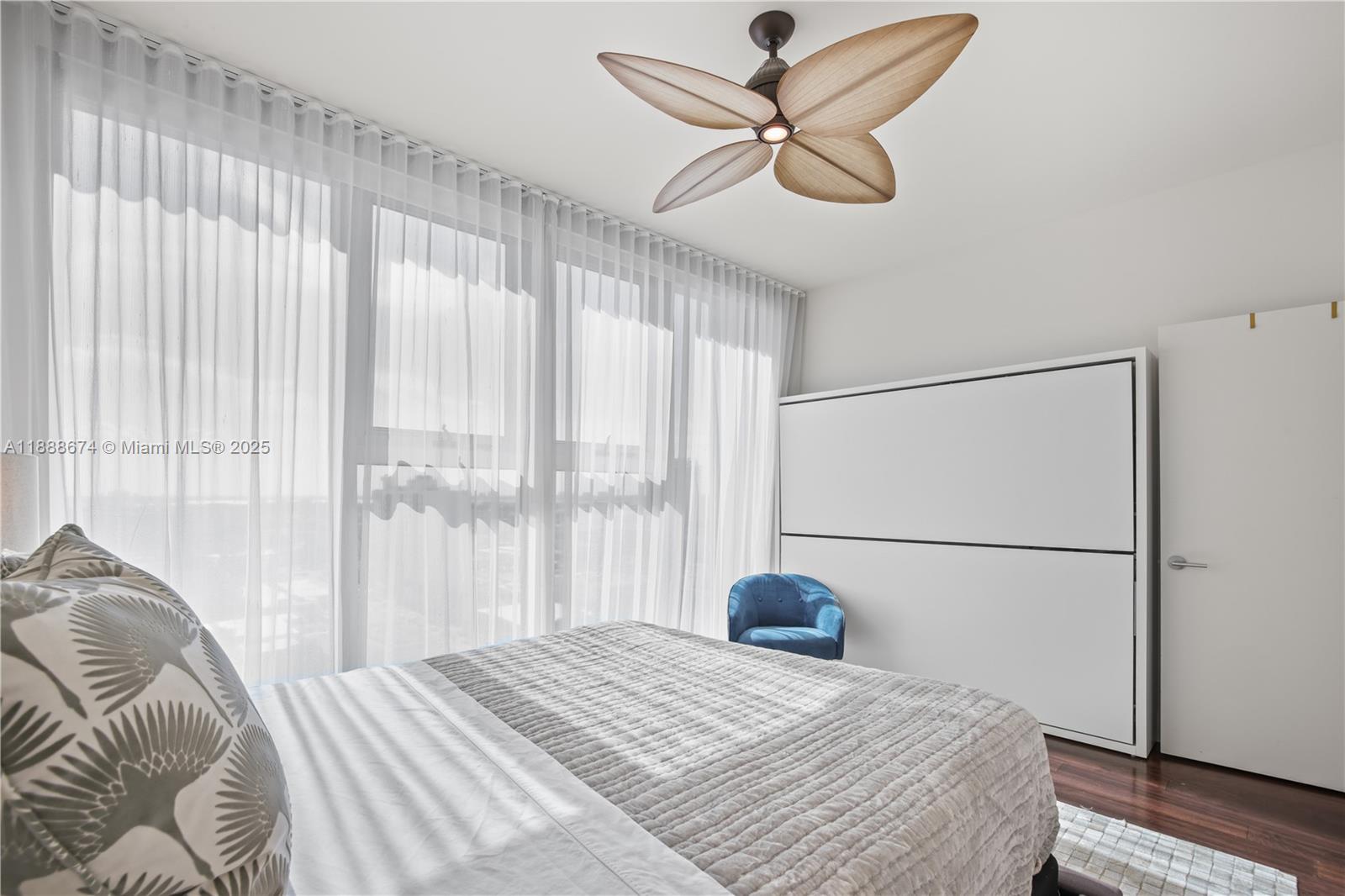 6899 Collins Avenue, Unit 1610 Miami Beach, FL 33141 - Photo 19 of 35 a bedroom with a large bed and a large window