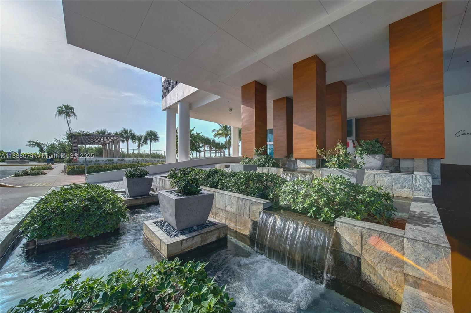 6899 Collins Avenue, Unit 1610 Miami Beach, FL 33141 - Photo 27 of 35 a view of a patio with couches table and chairs and potted plants