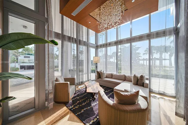 a dining room with furniture and a floor to ceiling window