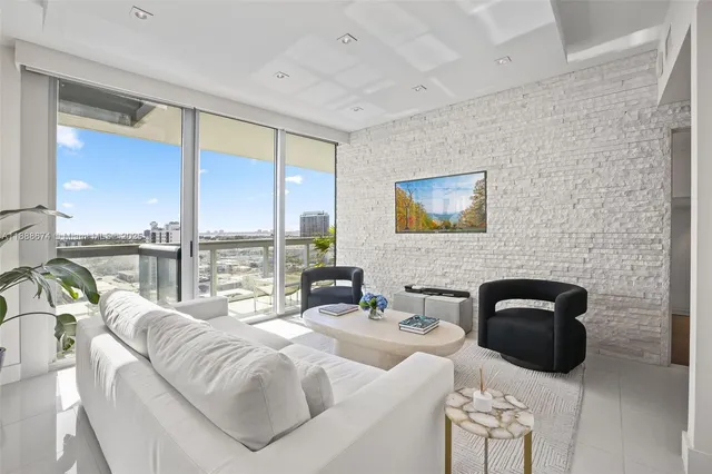 a bedroom with a bed a balcony a bed and a large window