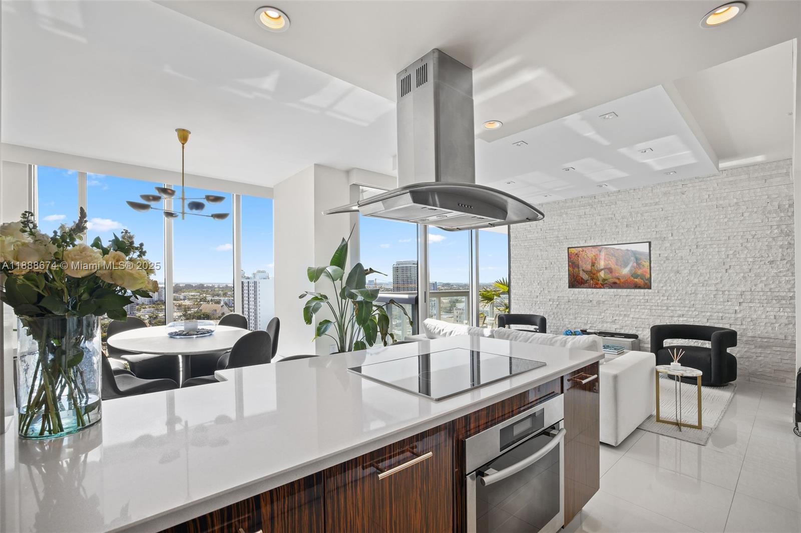 6899 Collins Avenue, Unit 1610 Miami Beach, FL 33141 - Photo 6 of 35 a kitchen with stainless steel appliances a sink a counter space and a view of living room