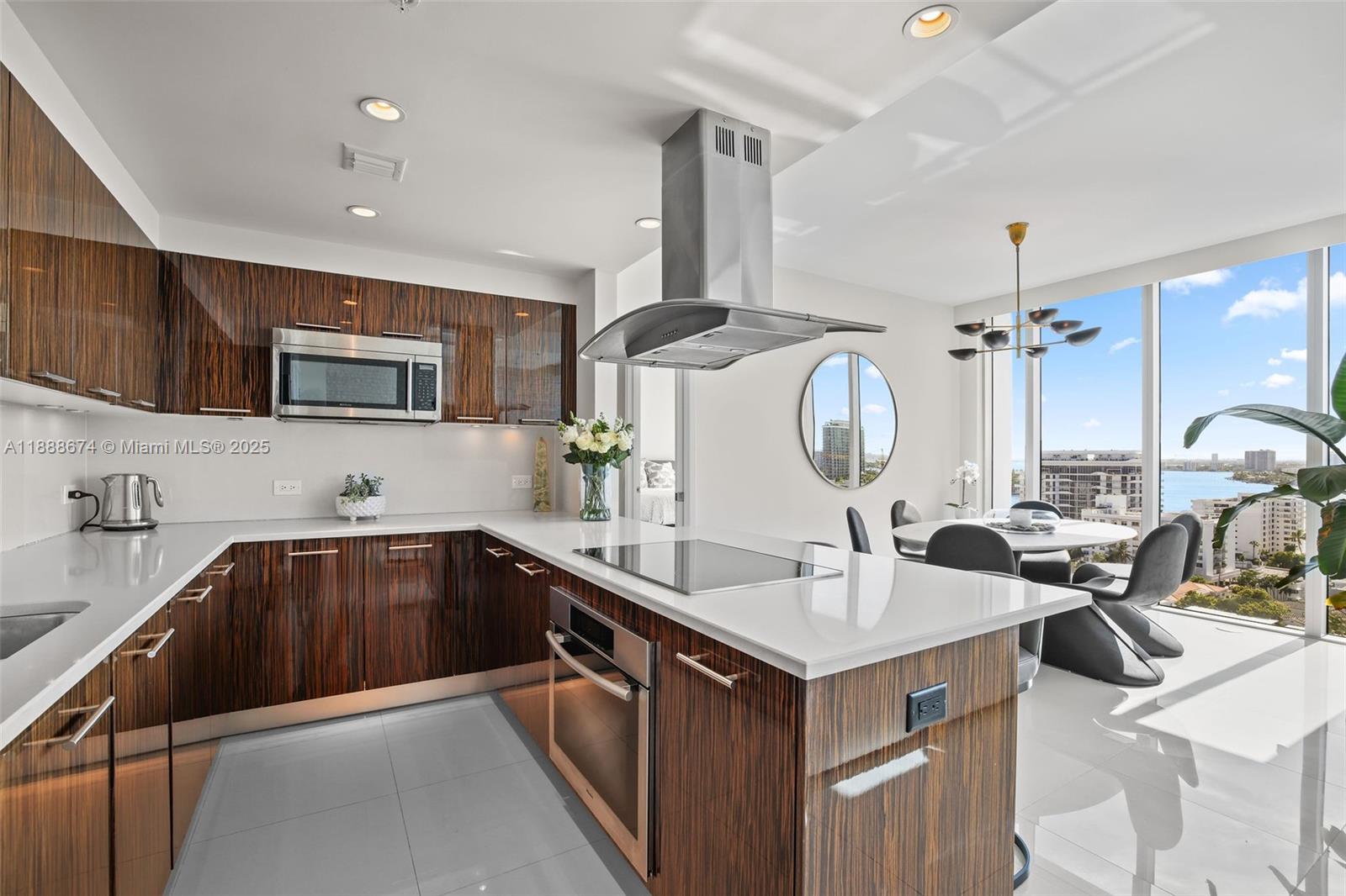 6899 Collins Avenue, Unit 1610 Miami Beach, FL 33141 - Photo 7 of 35 a kitchen with a sink stove and microwave