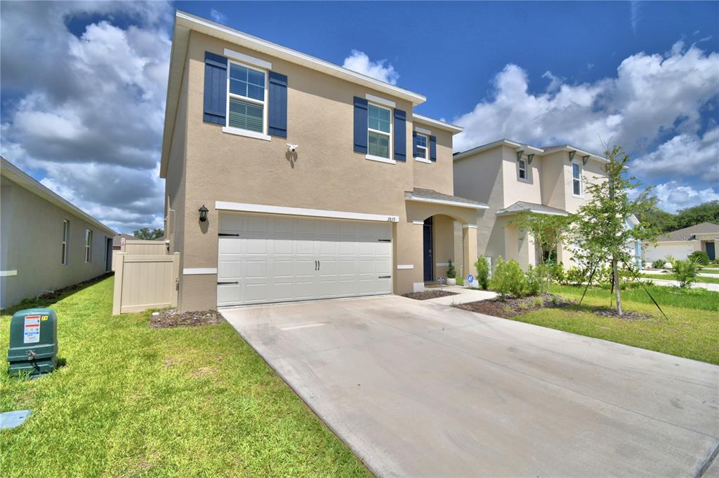 2839 Moulin Road Davenport, FL 33837 - Photo 3 of 75 a front view of a house with a yard and garage