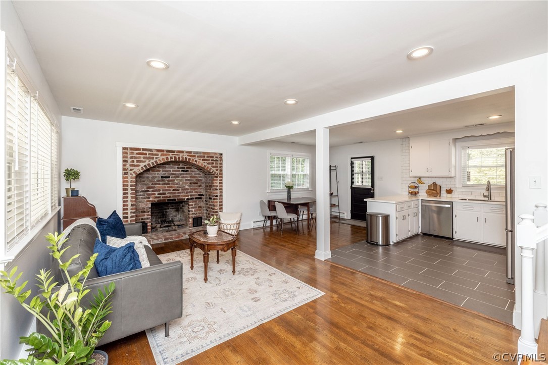 10500 Spring Run Road Chesterfield, VA 23832 - Photo 6 of 43 a living room with furniture a fireplace and a kitchen view
