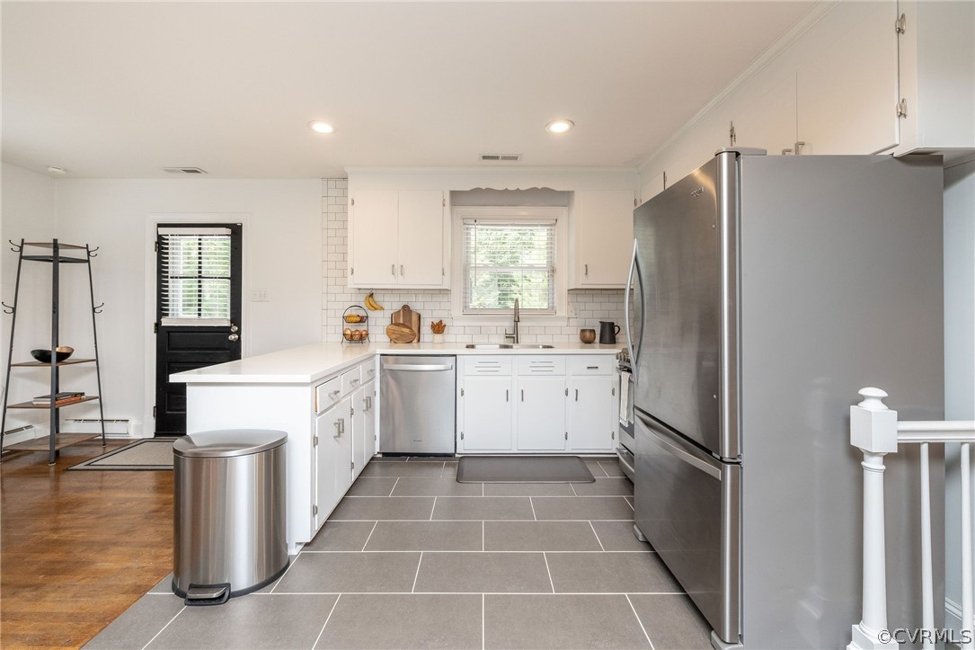 10500 Spring Run Road Chesterfield, VA 23832 - Photo 10 of 43 a kitchen with a refrigerator a sink and white cabinets