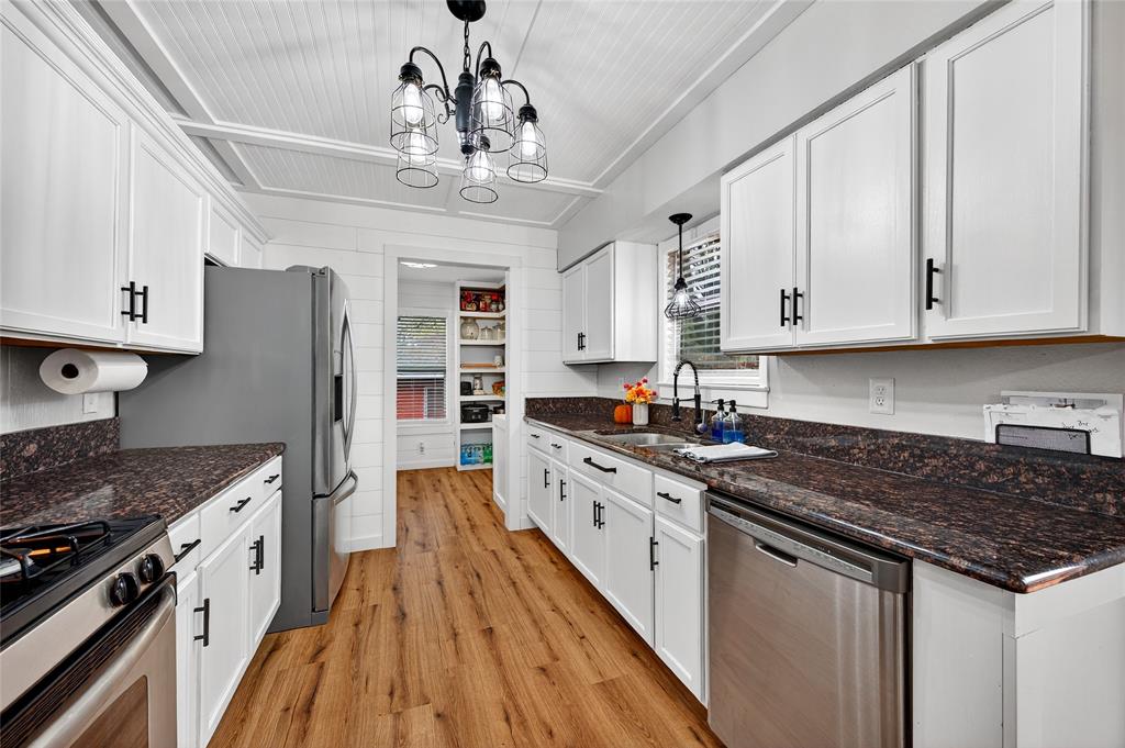 1115 Oak Ridge Drive Denison, TX 75020 - Photo 14 of 32 a kitchen with stainless steel appliances granite countertop a stove and a refrigerator