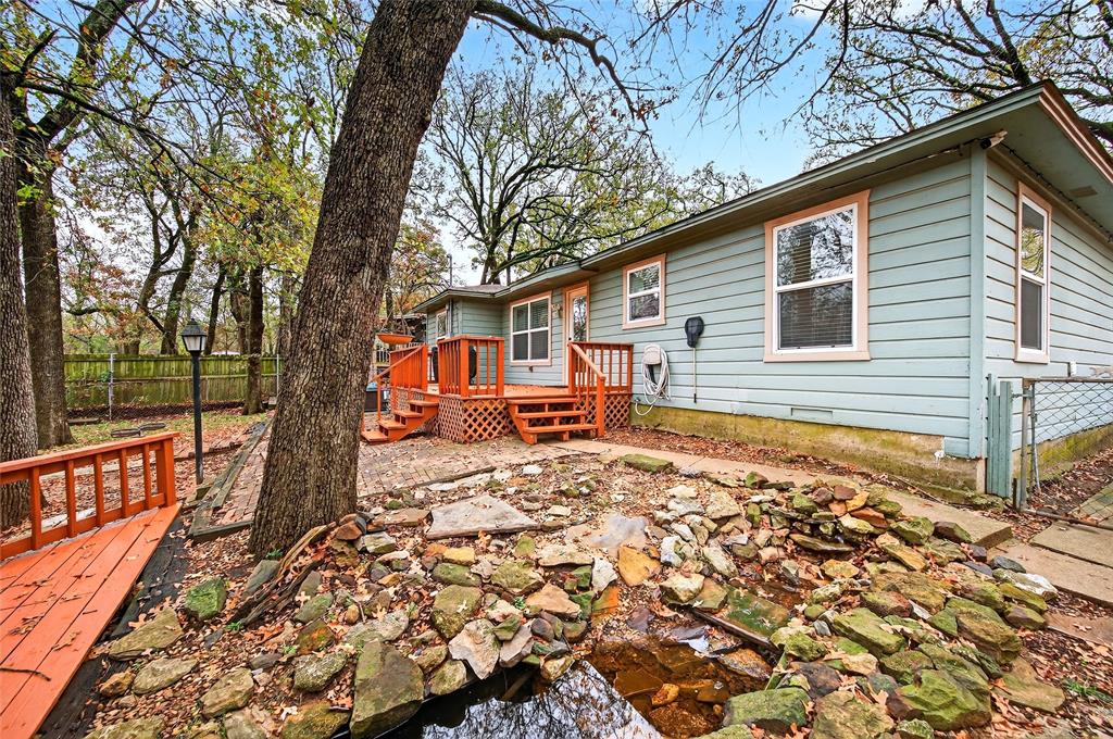 1115 Oak Ridge Drive Denison, TX 75020 - Photo 27 of 32 a backyard of a house with barbeque oven table and chairs