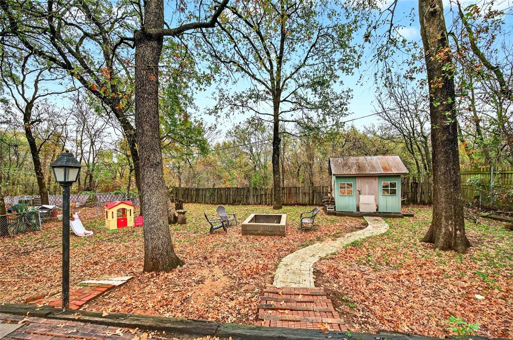 1115 Oak Ridge Drive Denison, TX 75020 - Photo 30 of 32 a front view of a house with large trees