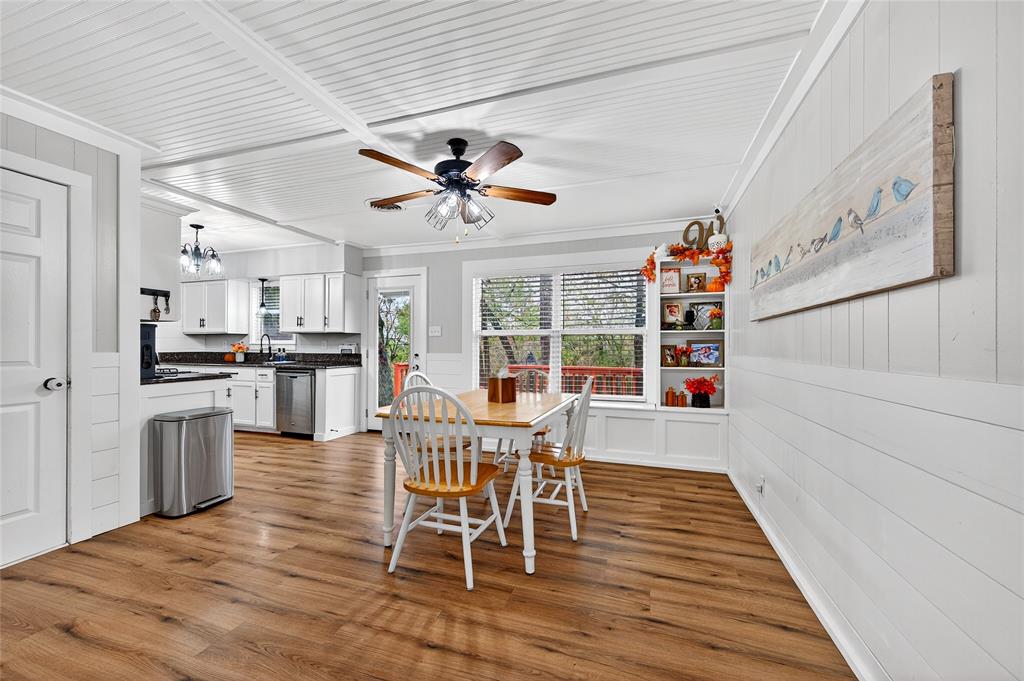 1115 Oak Ridge Drive Denison, TX 75020 - Photo 10 of 32 a view of a dining room with furniture window and wooden floor