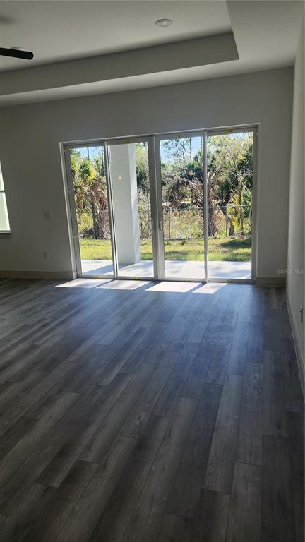 23469 Roscoe Avenue Punta Gorda, FL 33980 - Photo 11 of 26 a view of an empty room with a window and wooden floor