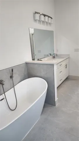 a bathroom with a sink a mirror and a shower