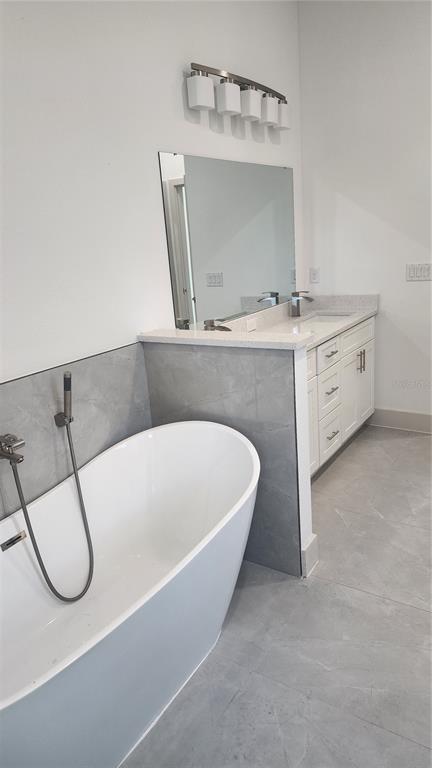 23469 Roscoe Avenue Punta Gorda, FL 33980 - Photo 16 of 26 a bathroom with a sink a mirror and a shower