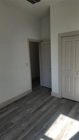 a view of hallway with wooden floor