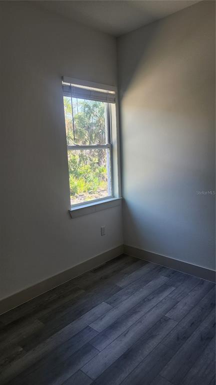 23469 Roscoe Avenue Punta Gorda, FL 33980 - Photo 20 of 26 a view of an empty room with wooden floor and a window