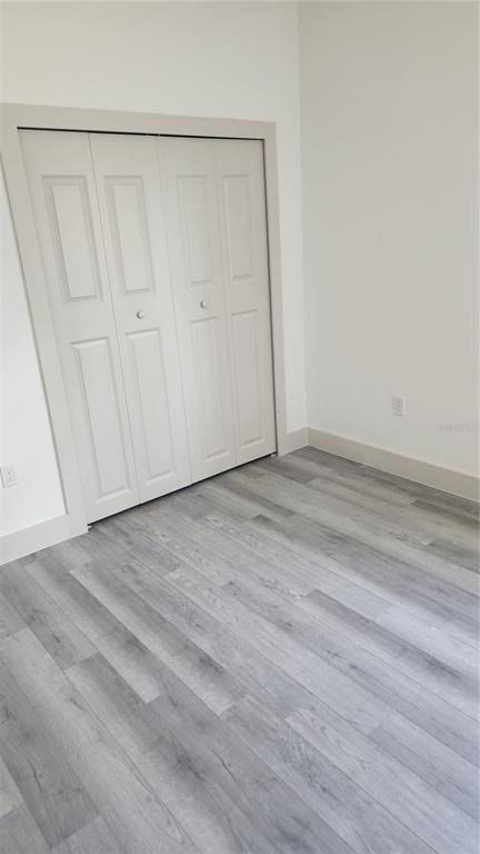 23469 Roscoe Avenue Punta Gorda, FL 33980 - Photo 21 of 26 a view of an empty room with wooden floor
