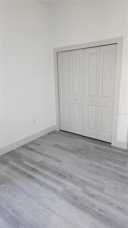 23469 Roscoe Avenue Punta Gorda, FL 33980 - Photo 23 of 26 a view of a room with wooden floor