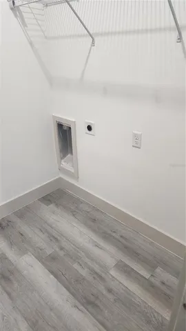 a view of a livingroom with wooden floor and a window