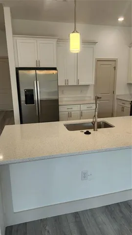 a kitchen with a sink and a refrigerator