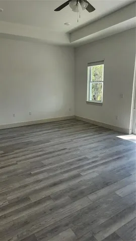 a view of an empty room and wooden floor
