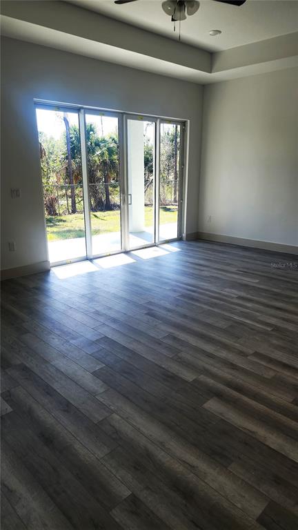 23469 Roscoe Avenue Punta Gorda, FL 33980 - Photo 10 of 26 an empty room with wooden floor and windows