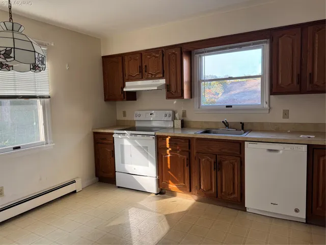 a kitchen with a sink stove and microwave