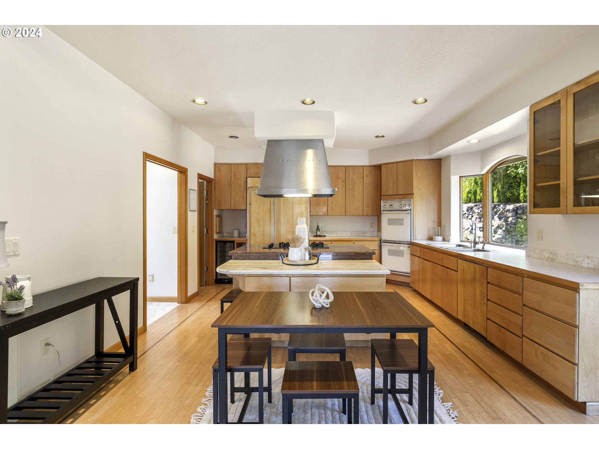 11400 Northwest Plainview Road Portland, OR 97231 - Photo 12 of 48 a kitchen with a table chairs stove and cabinets