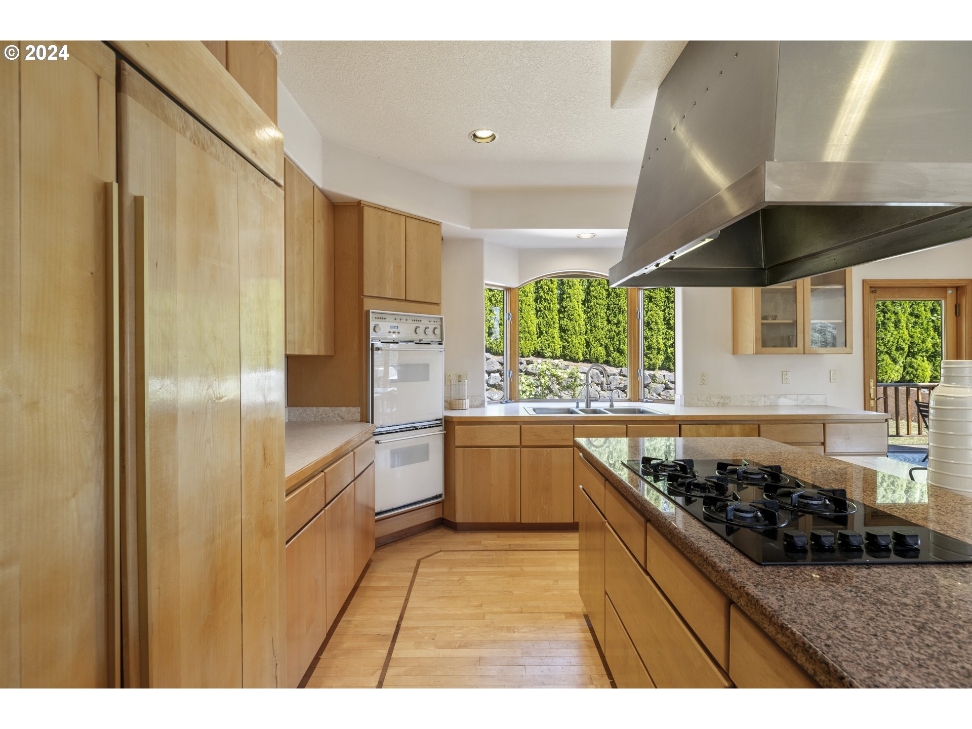 11400 Northwest Plainview Road Portland, OR 97231 - Photo 16 of 48 a kitchen with stainless steel appliances granite countertop a sink and a refrigerator