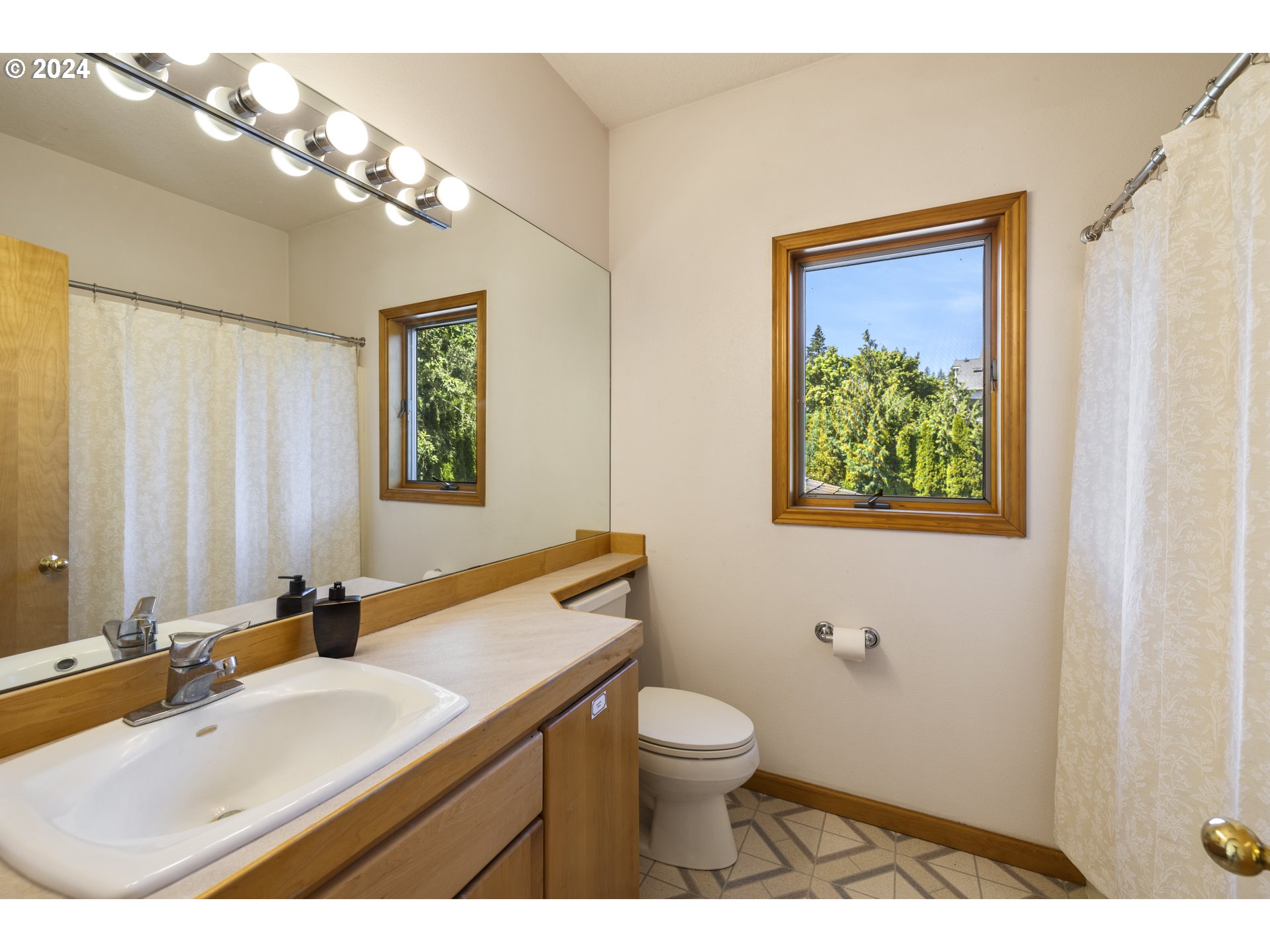11400 Northwest Plainview Road Portland, OR 97231 - Photo 27 of 48 a bathroom with a toilet sink and mirror