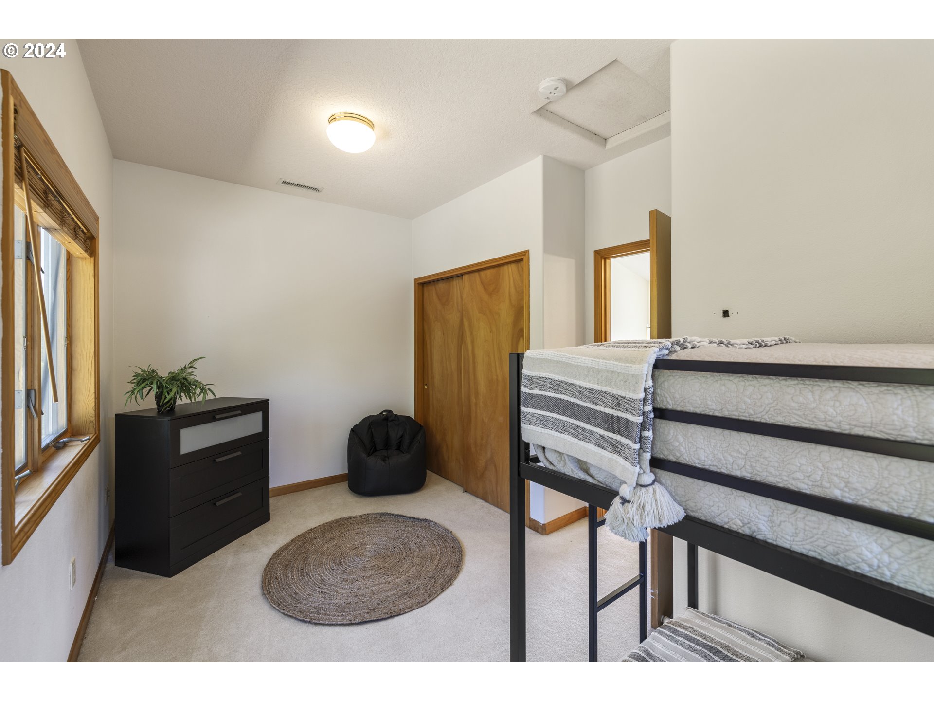 11400 Northwest Plainview Road Portland, OR 97231 - Photo 29 of 48 a bedroom with a bed and a chair