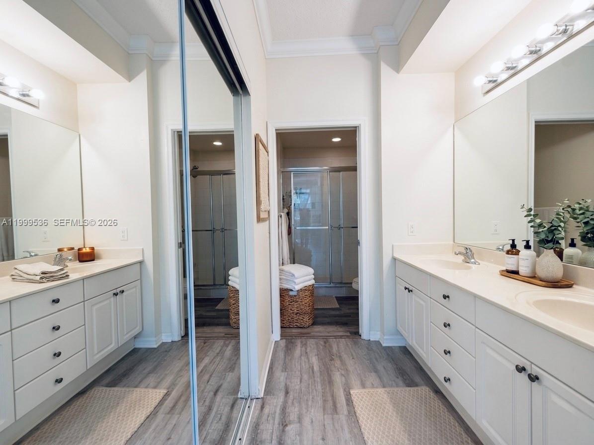 26 Royal Palm Way, Unit 304 Boca Raton, FL 33432 - Photo 14 of 38 a bathroom with a double vanity sink and mirror with shower