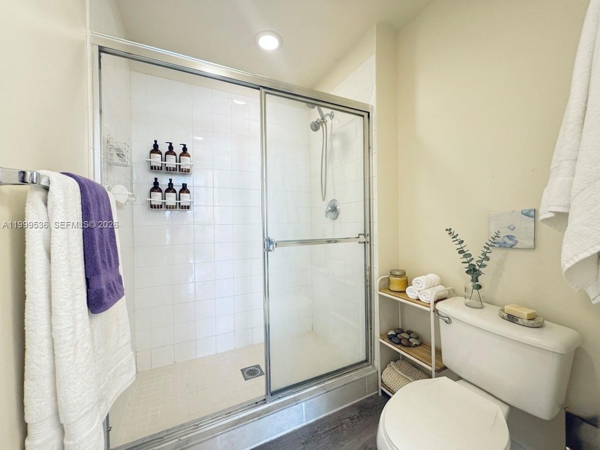 26 Royal Palm Way, Unit 304 Boca Raton, FL 33432 - Photo 18 of 38 a bathroom with a shower toilet and sink