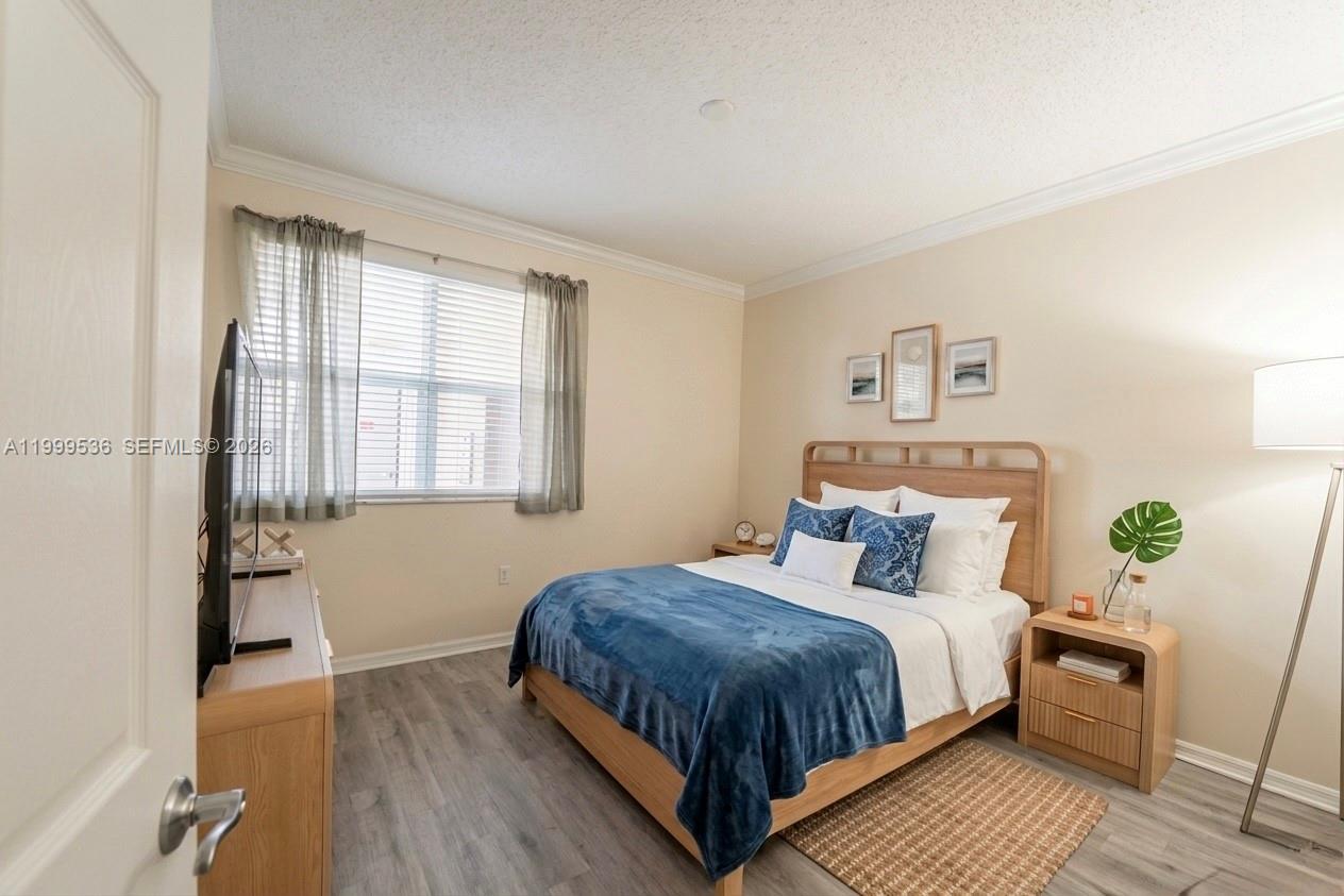26 Royal Palm Way, Unit 304 Boca Raton, FL 33432 - Photo 19 of 38 a bedroom with bed and wooden floor