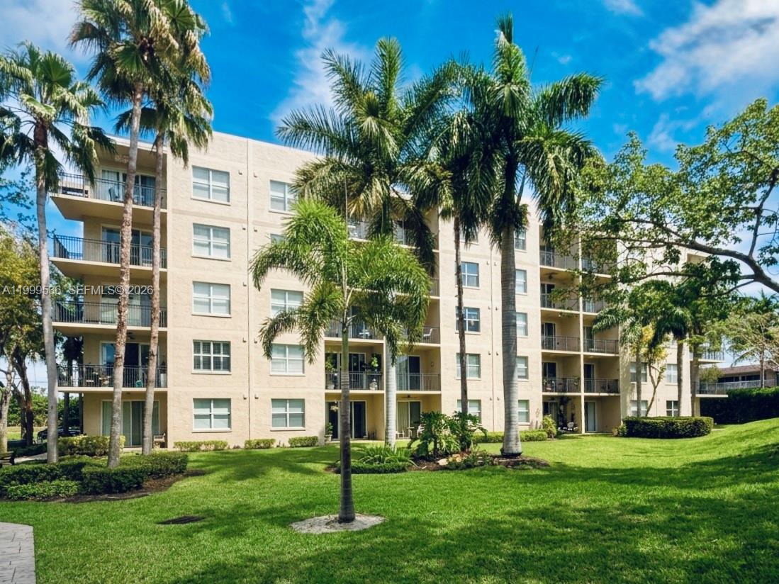 26 Royal Palm Way, Unit 304 Boca Raton, FL 33432 - Photo 26 of 38 a front view of a multi story building with yard
