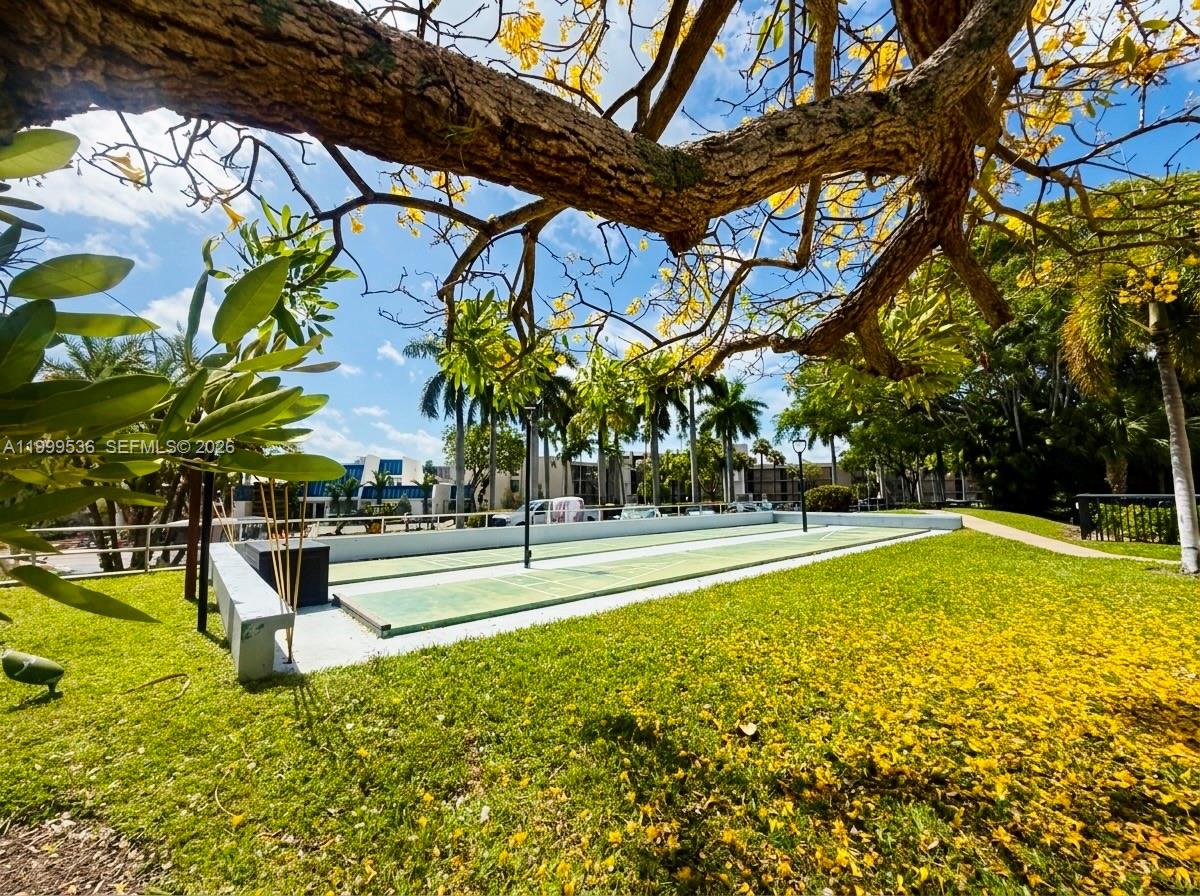 26 Royal Palm Way, Unit 304 Boca Raton, FL 33432 - Photo 27 of 38 a view of a swimming pool with a bench and trees in the background