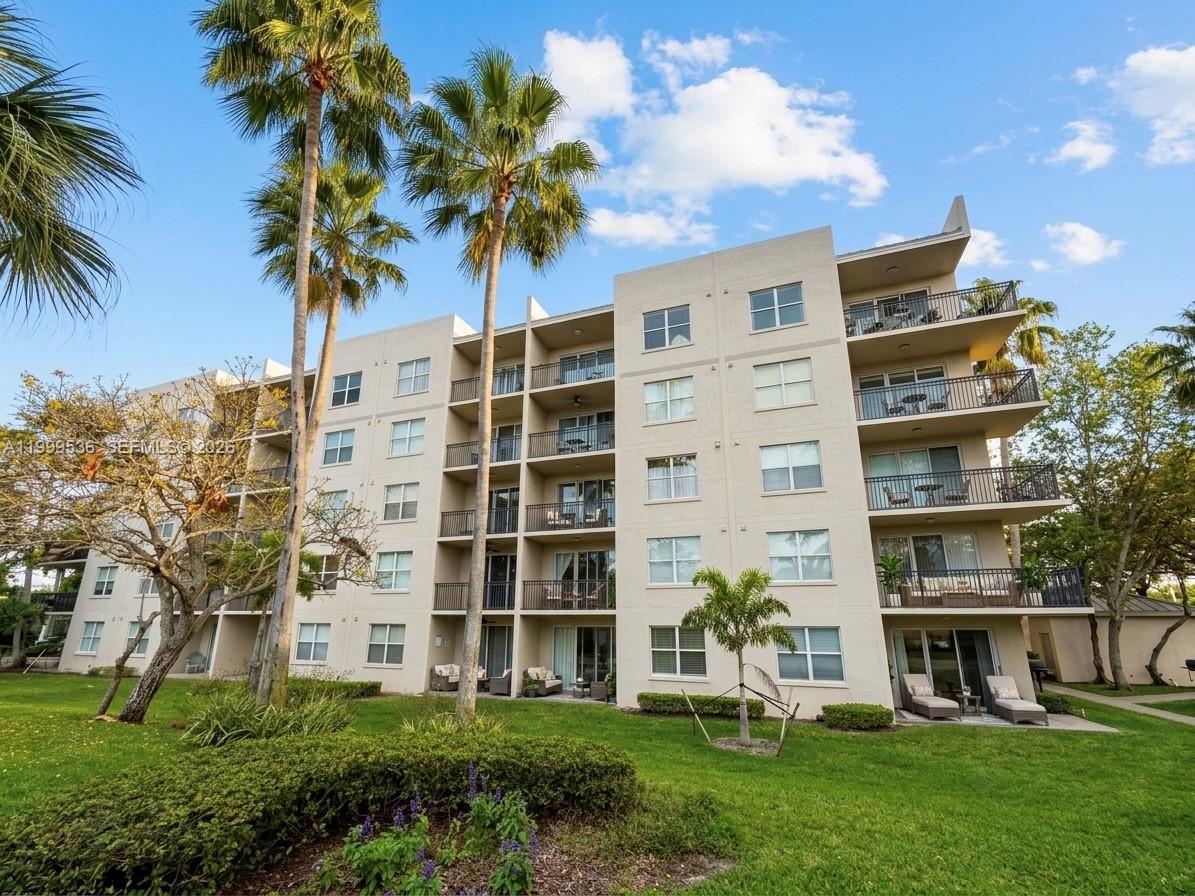 26 Royal Palm Way, Unit 304 Boca Raton, FL 33432 - Photo 29 of 38 a front view of multi story residential apartment building with yard and green space