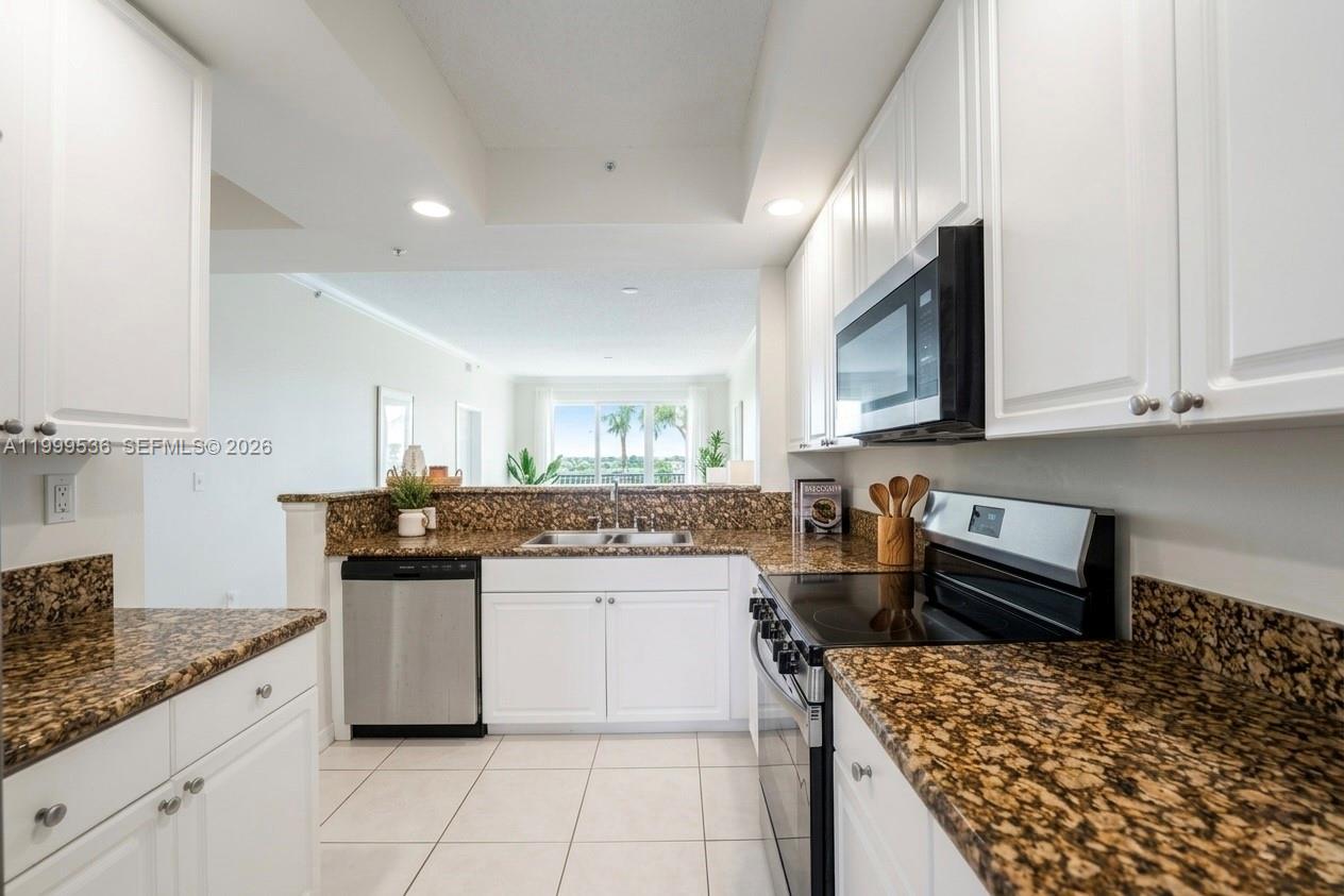 26 Royal Palm Way, Unit 304 Boca Raton, FL 33432 - Photo 5 of 38 a kitchen with stainless steel appliances kitchen island granite countertop a sink and cabinets
