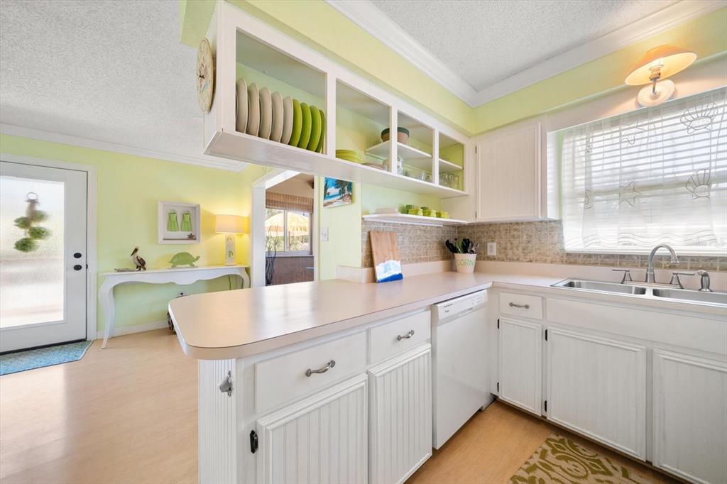800 East Gulf Boulevard, Unit 5 Indian Rocks Beach, FL 33785 - Photo 12 of 52 a kitchen with cabinets a sink and appliances